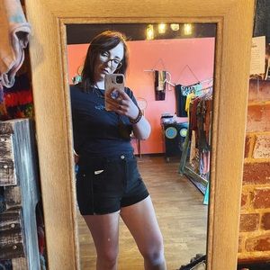 Black distressed denim shorts with rolled hem